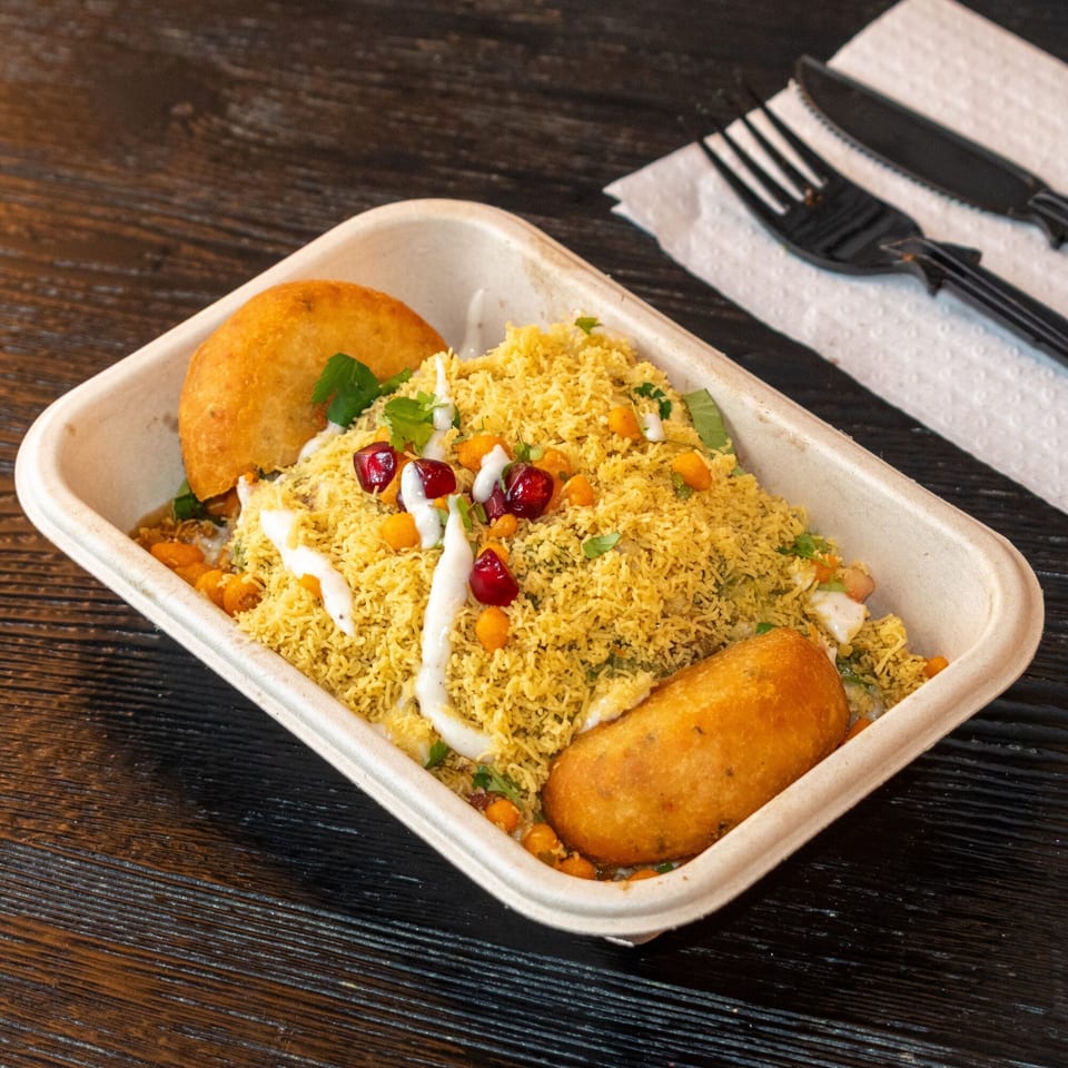 Bombay Baking Co.'s savory Indian snack, sev puri, with two fried pastries, pomegranate, and sauce.