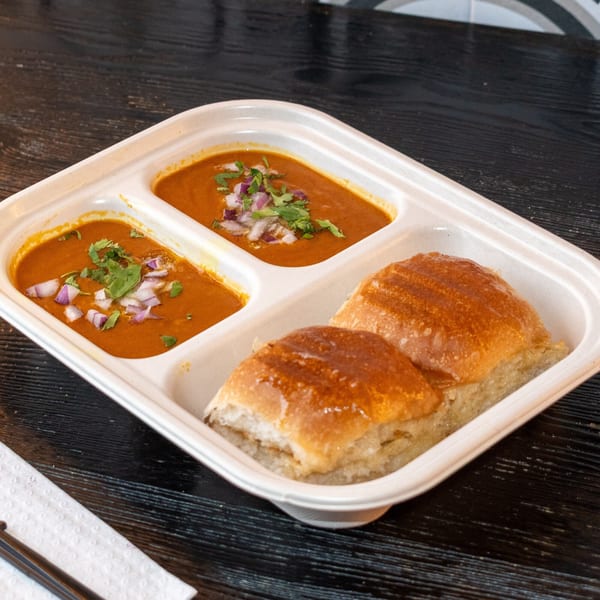 Pav Bhaji from Bombay Baking Co., with two portions of bhaji and two pav buns.